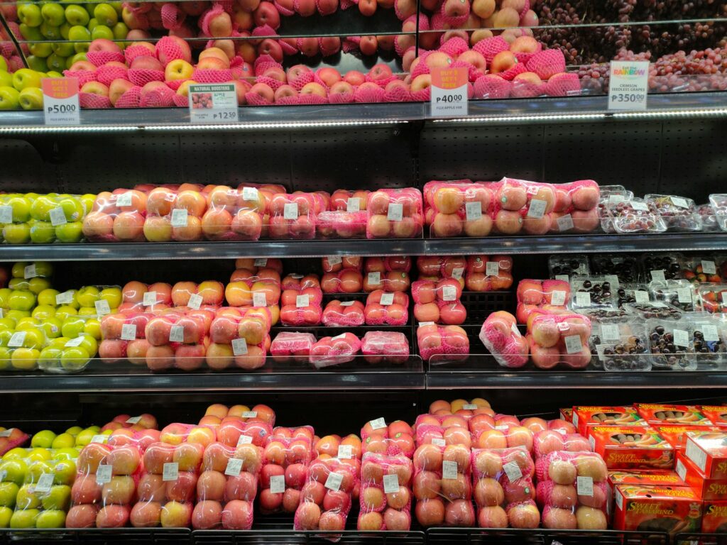 a display in a grocery store filled with lots of apples