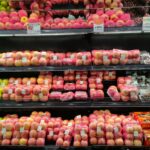 a display in a grocery store filled with lots of apples