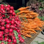 a bunch of radishes and carrots on a table