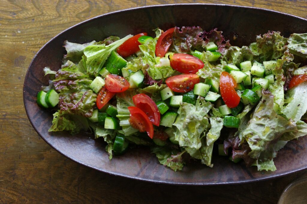 A bowl of salad on a wooden table