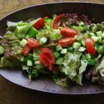 A bowl of salad on a wooden table